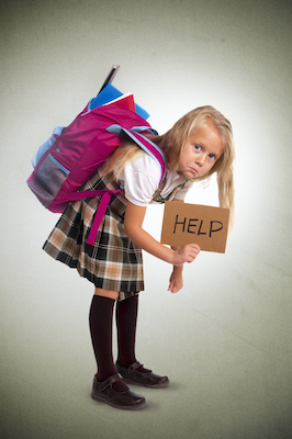 Kid with posture problems due to a heavy backpack